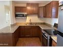 U-shaped kitchen with wood cabinets, granite countertops, and stainless steel appliances at 925 E Henry St, Tempe, AZ 85288