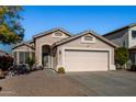 One story house with pink garage door and nicely landscaped front yard at 12742 W Ash St, El Mirage, AZ 85335
