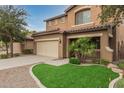 Two-story house with beige exterior, landscaped yard, and a two-car garage at 398 W Lyle Ave, San Tan Valley, AZ 85140