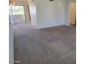 Spacious living room with neutral carpeting and access to a balcony at 4201 E Camelback Rd # 14, Phoenix, AZ 85018