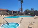 Inviting community pool and spa area with lounge chairs at 4201 E Camelback Rd # 14, Phoenix, AZ 85018