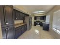 Kitchen with dark cabinets, granite countertops, and stainless steel appliances at 9028 N 48Th Dr, Glendale, AZ 85302