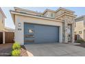 Two-story house with stone and stucco exterior, gray garage door at 10331 W Adam Ave, Peoria, AZ 85382