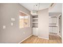 Dining area with built-in shelving and hardwood floors at 12221 W Bell Rd # 359, Surprise, AZ 85378