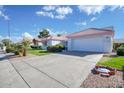 House exterior showcasing garage and front yard at 14129 W Sky Hawk Dr, Sun City West, AZ 85375