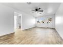 Bright living room with wood-look tile floors and ceiling fan at 1757 W Sunland Ave, Phoenix, AZ 85041