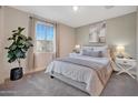 Bright bedroom with large window and neutral decor at 18322 W Long Lake Rd, Goodyear, AZ 85338