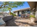 Outdoor patio area with seating and brick paving at 21002 N Totem Dr, Sun City West, AZ 85375