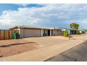 Ranch style home with a landscaped front yard, driveway, and attached garage at 6044 E Decatur St, Mesa, AZ 85205