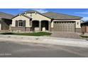 Well-maintained single-story house with a two-car garage and neat landscaping at 16068 W Questa Dr, Surprise, AZ 85387