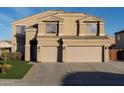 Tan two-story house, two-car garage, and front yard at 1807 S 234Th Ln, Buckeye, AZ 85326