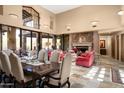 Spacious living area with fireplace, dining table, and high ceilings at 27939 N 100Th Pl, Scottsdale, AZ 85262