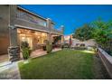 Spacious backyard with a covered patio, lush lawn, and fire pit at 2811 E Dunbar Dr, Phoenix, AZ 85042