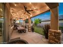 Covered patio with string lights, outdoor furniture, and a dining table at 2811 E Dunbar Dr, Phoenix, AZ 85042
