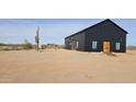 Stylish black barn-style house on a desert lot at 30314 W Wildcat Dr, Wittmann, AZ 85361