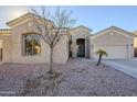 Single-story home with a two-car garage and desert landscaping at 9443 W Melinda Ln, Peoria, AZ 85382