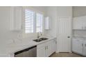 Modern kitchen with white shaker cabinets and a double sink at 9443 W Melinda Ln, Peoria, AZ 85382