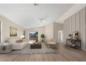 Bright living room with a beige couch and sliding glass doors at 10449 W Windsor Blvd, Glendale, AZ 85307