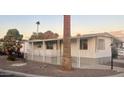 Mobile home exterior with covered patio and palm trees at 11411 N 91St Ave # 156, Peoria, AZ 85345