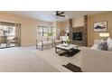 Bright living room with stone fireplace, and access to balcony at 21320 N 56Th St # 2175, Phoenix, AZ 85054