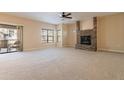 Spacious living room with stone fireplace and access to balcony at 21320 N 56Th St # 2175, Phoenix, AZ 85054