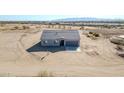 New single-story house on a large lot, aerial view at 21345 W Sleepy Ranch Rd, Wittmann, AZ 85361