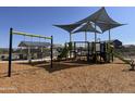 Modern playground with swings, slides, climbing structures, and shaded seating at 24126 W Sunland Ave, Buckeye, AZ 85326