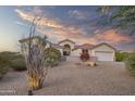 Lovely desert landscape and single story home with three car garage at 730 E Mesquite St, Phoenix, AZ 85086