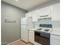 White kitchen cabinets, stove, and refrigerator included at 2301 E University Dr # 339, Mesa, AZ 85213