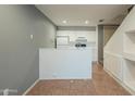 Simple kitchen features white cabinets, a breakfast bar, and tile flooring at 2301 E University Dr # 339, Mesa, AZ 85213