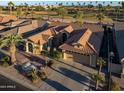 Single-story home with tile roof, driveway, and landscaping; golf course view at 3533 N 159Th Ln, Goodyear, AZ 85395
