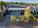 Home with solar panels, patio, seating area, and a view of the golf course at 3533 N 159Th Ln, Goodyear, AZ 85395