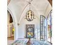 Grand entryway with high ceilings, a unique light fixture, and modern art at 6240 N 59Th Pl, Paradise Valley, AZ 85253