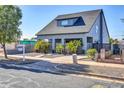 Modern home with a gray exterior, gated driveway, and palm trees at 826 N 11Th Ave, Phoenix, AZ 85007