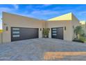 Two-car garage with modern doors and desert landscaping at 8300 E Dixileta Dr # 279, Scottsdale, AZ 85266