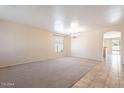 Spacious living room with carpet and tile flooring, neutral wall colors at 10419 E Kiva Ave, Mesa, AZ 85209
