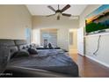 Main bedroom with a large bed, ceiling fan, and lots of natural light at 14027 N 133Rd Dr, Surprise, AZ 85379