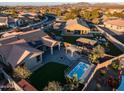 Aerial view of a home with a large backyard, including a spa and solar panels at 15053 S 181St Dr, Goodyear, AZ 85338