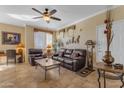 Living room with leather furniture, coffee table, and ceiling fan at 1941 S Pierpont Dr # 2061, Mesa, AZ 85206