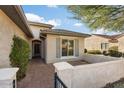 Inviting front entry with brick walkway and stucco exterior at 26631 W Runion Dr, Buckeye, AZ 85396