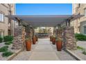 Stone-paved walkway with pergola and potted plants at 5350 E Deer Valley Dr # 3418, Phoenix, AZ 85054