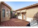 Courtyard with tile flooring, a door to the house, and a grill at 17937 W Weatherby Dr, Surprise, AZ 85374