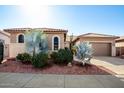 Tan stucco house with tile roof, two-car garage, and desert landscaping at 17937 W Weatherby Dr, Surprise, AZ 85374