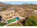 Aerial view of a two-story house with a pool and backyard, surrounded by desert landscape at 2305 W Long Shadow Trl, Phoenix, AZ 85085