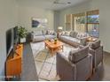 Spacious living room featuring modern furniture and large windows at 3576 N Carlton St, Buckeye, AZ 85396