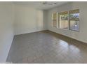 Bright and airy spare bedroom with tile floors and large windows at 3576 N Carlton St, Buckeye, AZ 85396