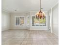 Spacious dining room with tile floors, large windows with plantation shutters, and a chandelier at 7494 E Nestling Way, Scottsdale, AZ 85255