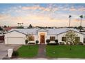 Stunning curb appeal of a single-story home with a beautifully landscaped yard at 115 S Galaxy Dr, Chandler, AZ 85226