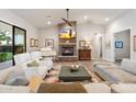 Open living space with a stone fireplace, comfy seating, and a grand piano at 115 S Galaxy Dr, Chandler, AZ 85226