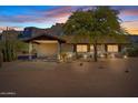 Desert house exterior at dusk, featuring a carport and landscaping at 125 N Val Vista Rd, Apache Junction, AZ 85119